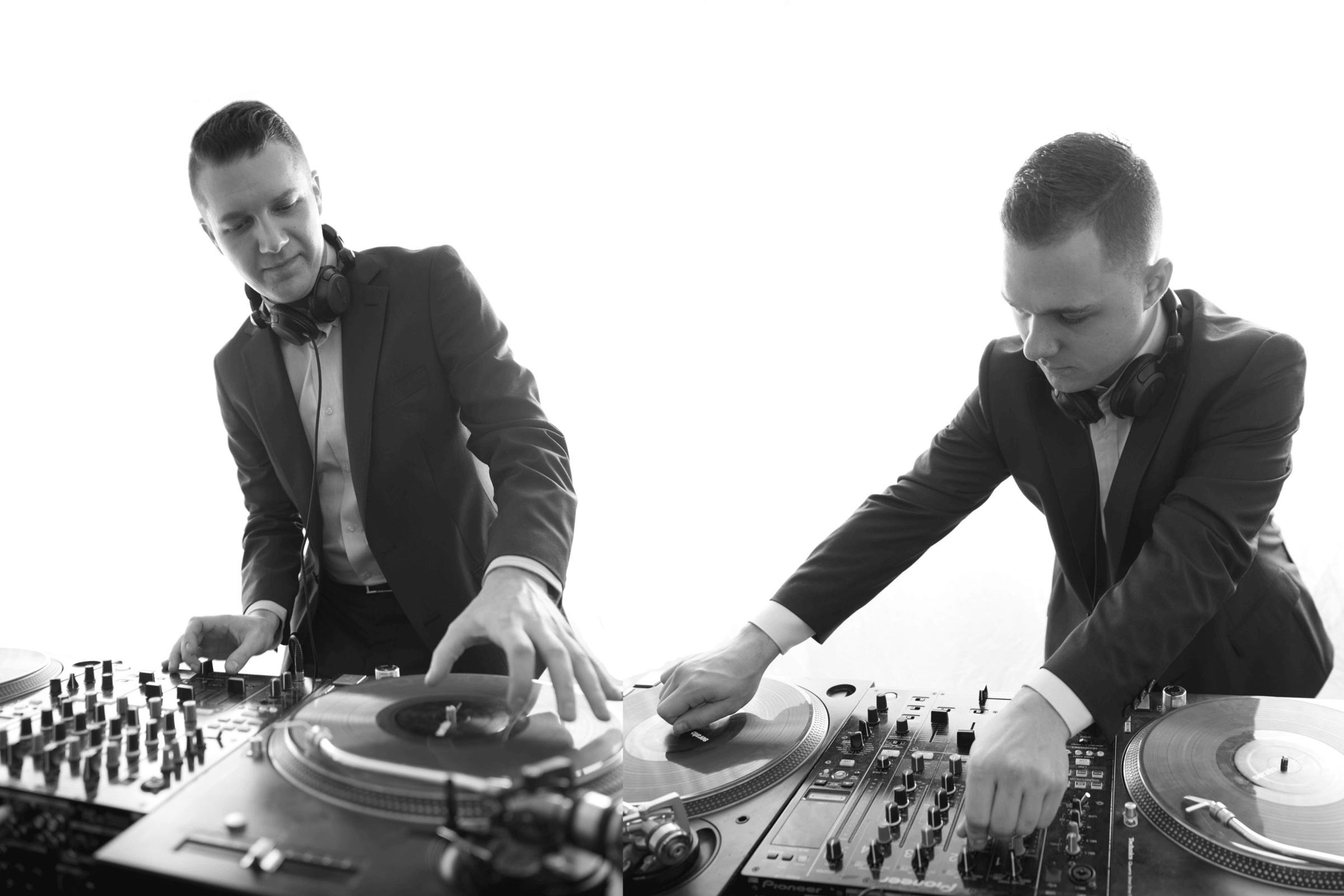 Two DJs standing in front of a turntable playing music
