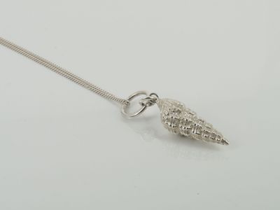 Long necklace with a heavy whelk shell