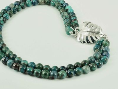 Necklace - a monstera leaf with rich, tropical coloured beads
