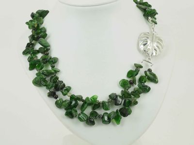 Necklace - a monstera leaf with rich, tropical coloured beads