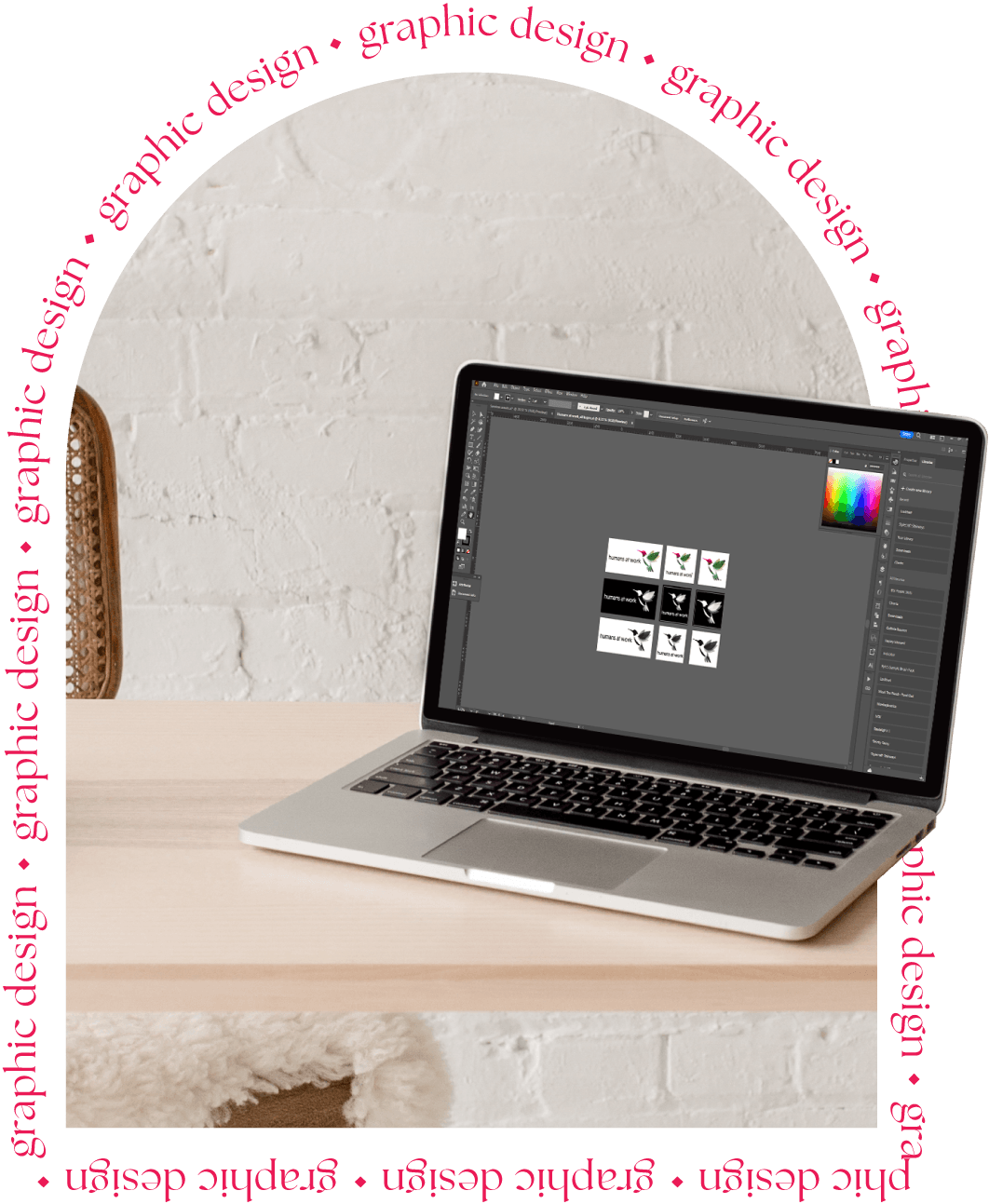 A laptop displaying a design project in Photoshop, framed by repeated text 'graphic design' in pink, with a light wooden table background