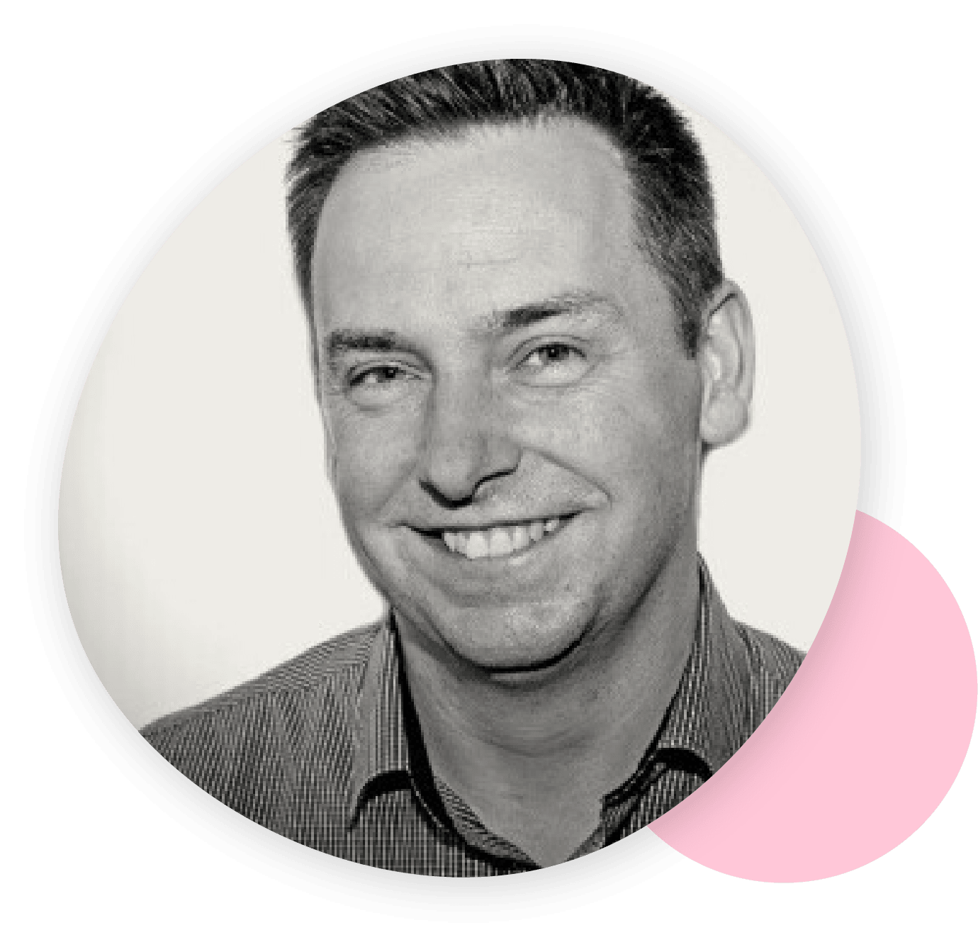 Black and white portrait of a smiling man with short hair, wearing a striped shirt, framed by an abstract shape with a pink accent