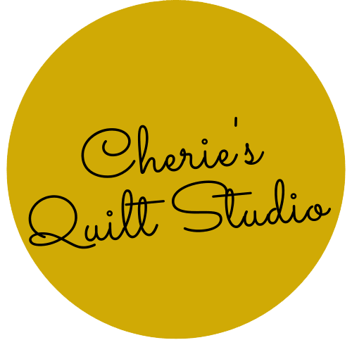  Cherie’s Quilt Studio logo features a mustard yellow circle with the business name in black cursive font