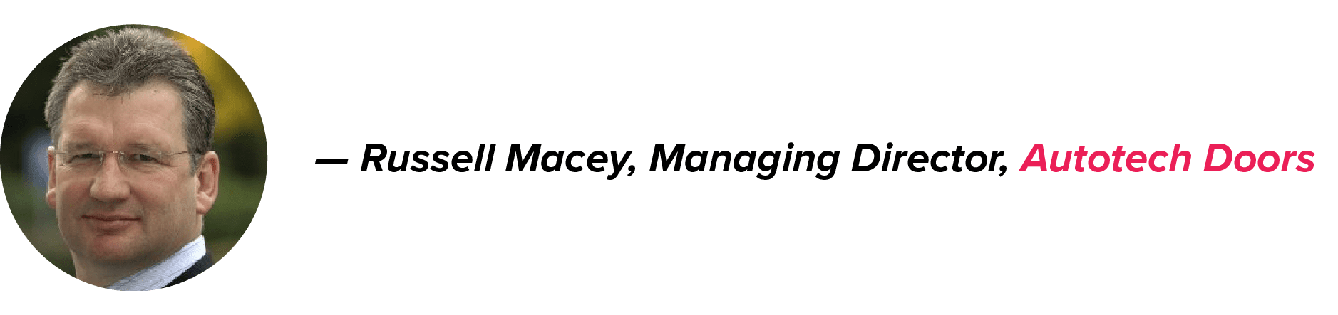 Russell Macey, Managing Director of Autotech Doors, outdoors in glasses and a white shirt, with his name in black and company name in pink