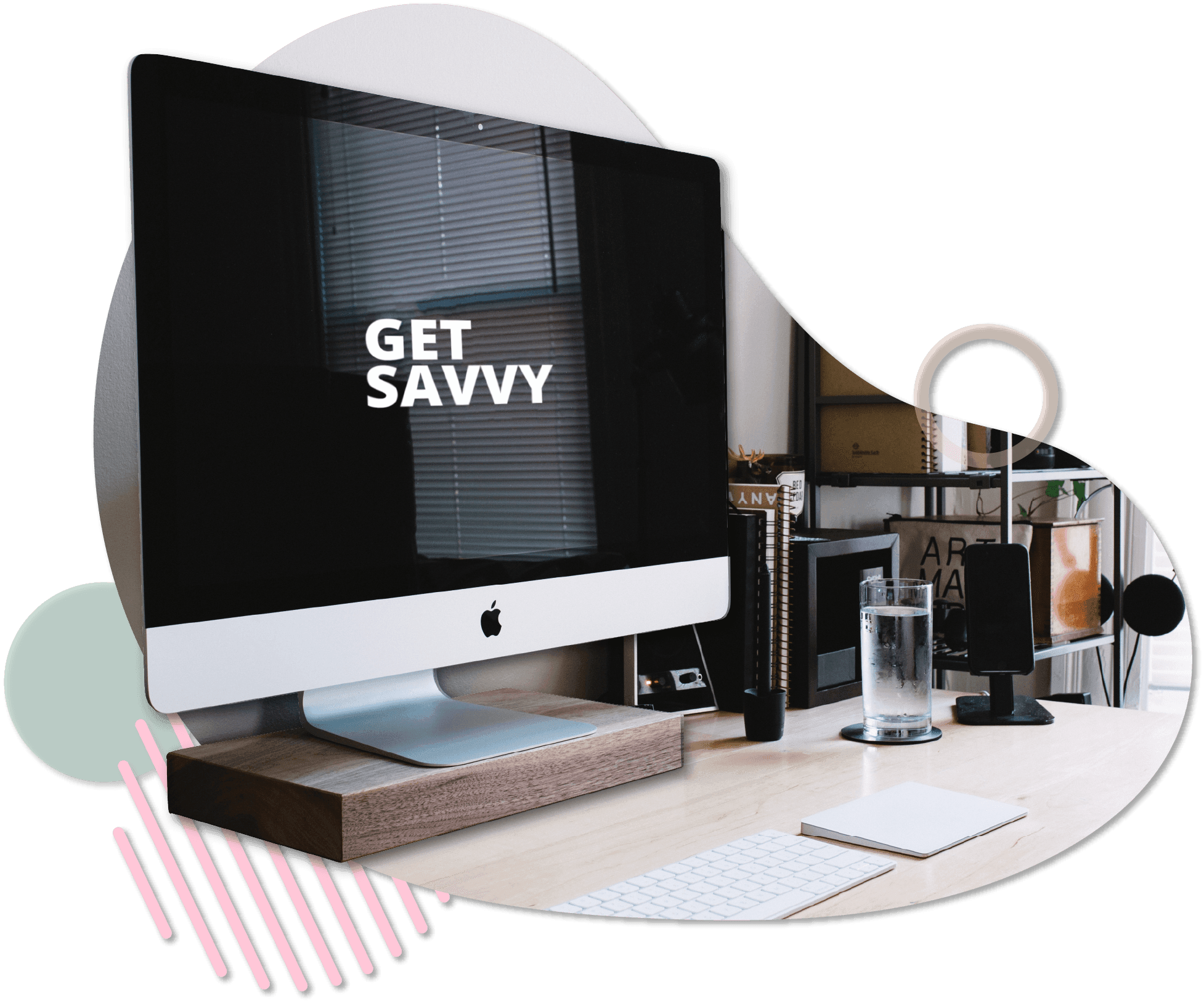 Desktop computer on a modern desk with "Get Savvy" displayed on the screen, surrounded by vibrant graphic shapes