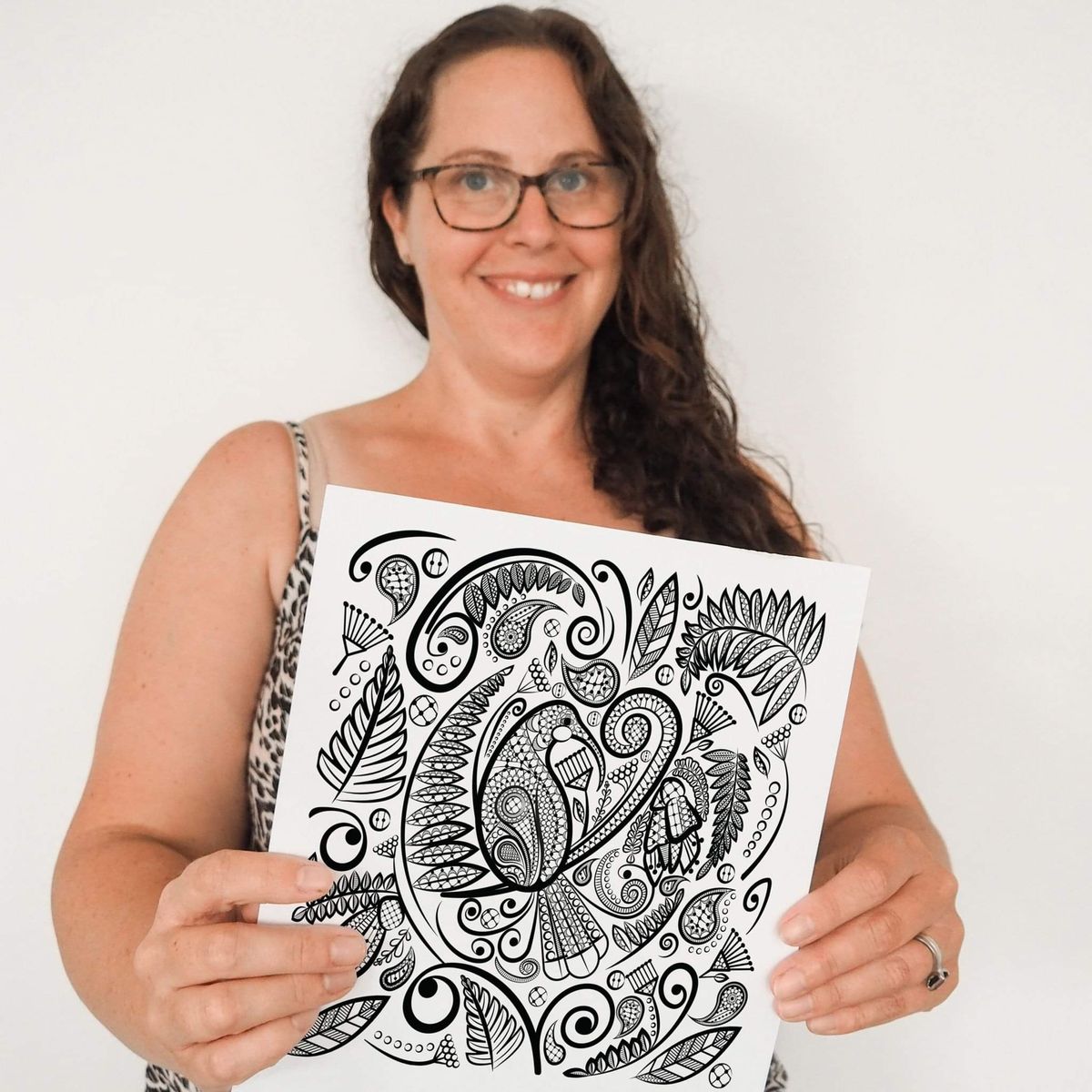 Anna Mollekin holding the original lace artwork behind Huia's Lustrous Lacework