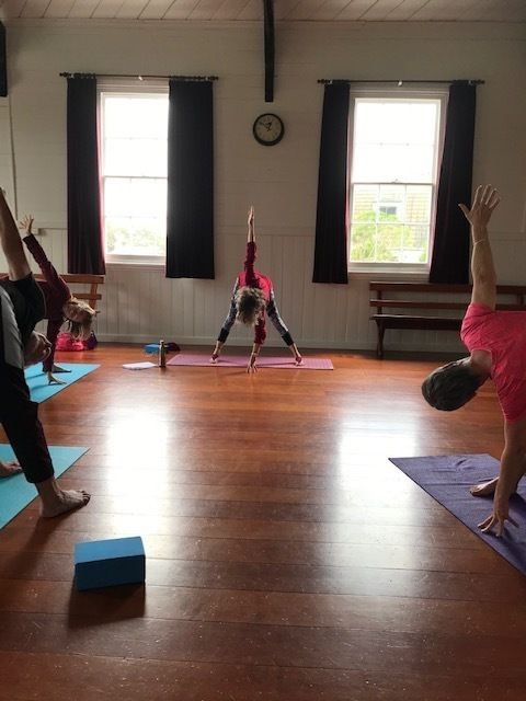 Jose Kakebeeke demonstrating a hatha yoga pose at a class in the Kuaotunu Hall