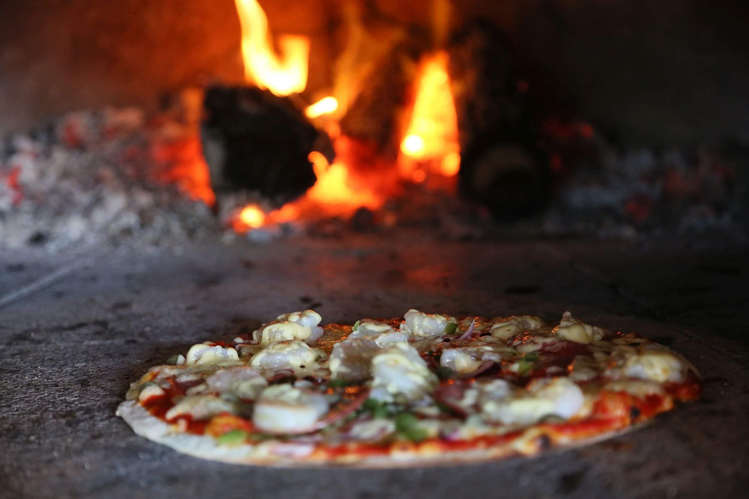 Pizza just out of the wood-fired pizza oven at Luke's Kitchen (Kuaotunu)