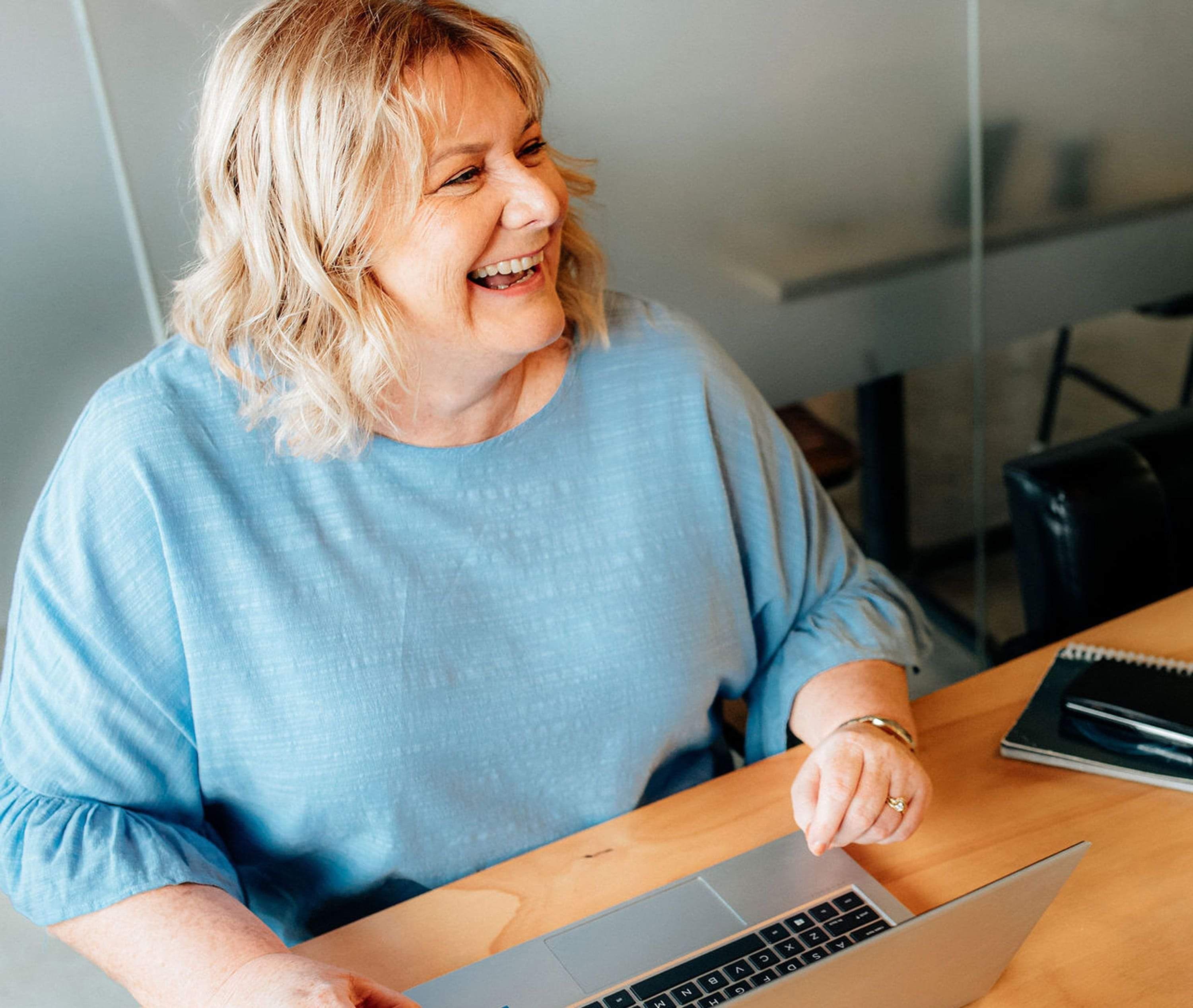 Image of Helen Laidlaw, Hamilton Business Advisor laughing with a client. Waikato, New Zealand.