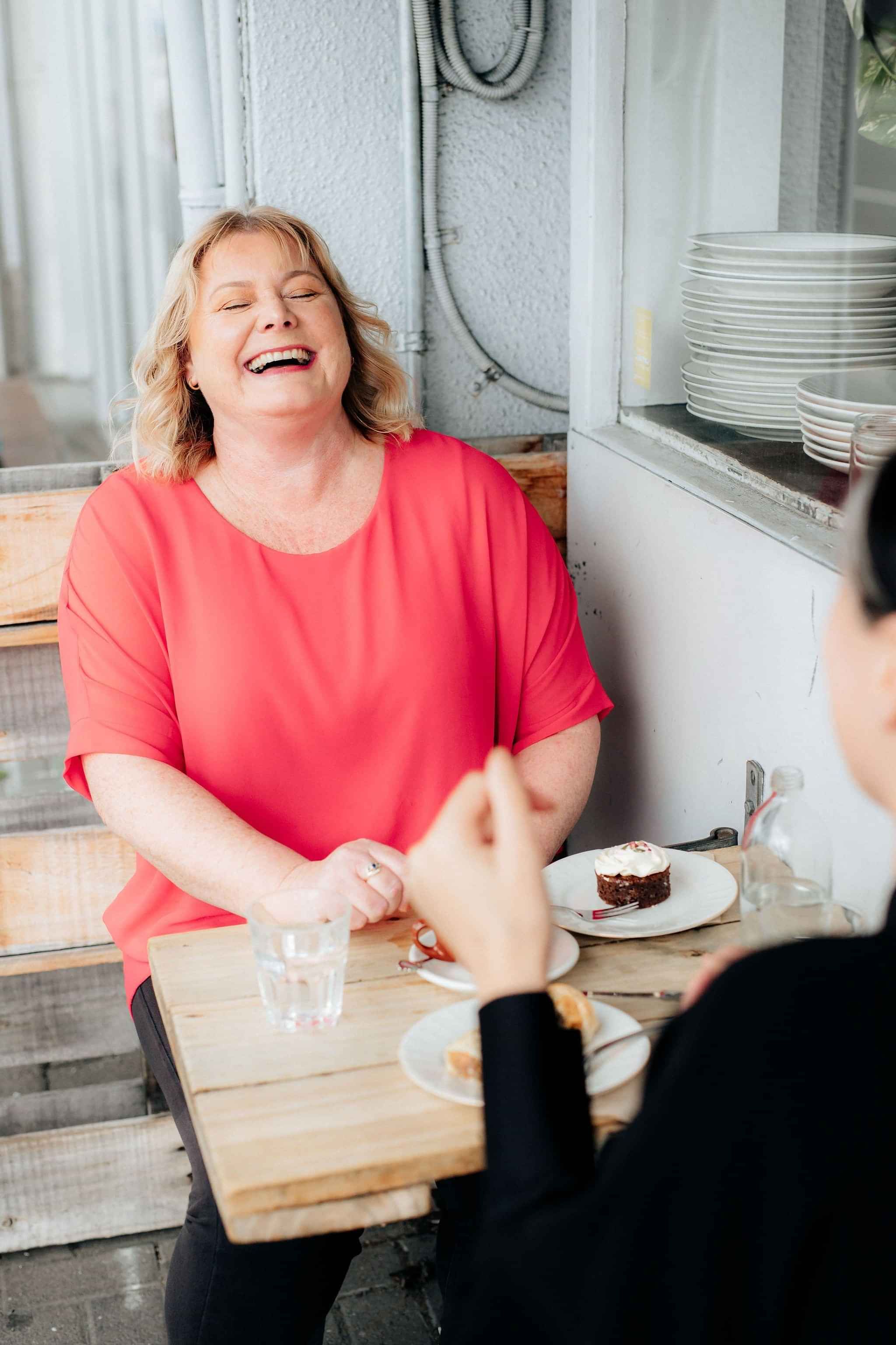 Image of Helen Laidlaw, Hamilton Business Advisor laughing with a client. Waikato, New Zealand.
