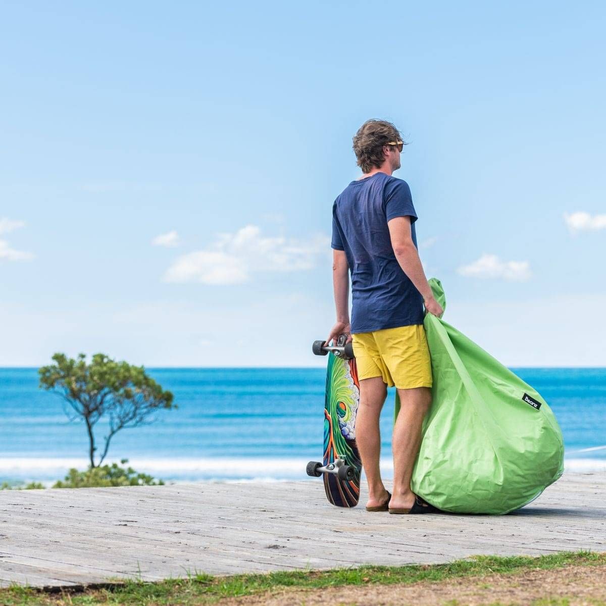 A yellow fish tail hangs in front of a concrete wall with dark shadowing giving it a moody vibe