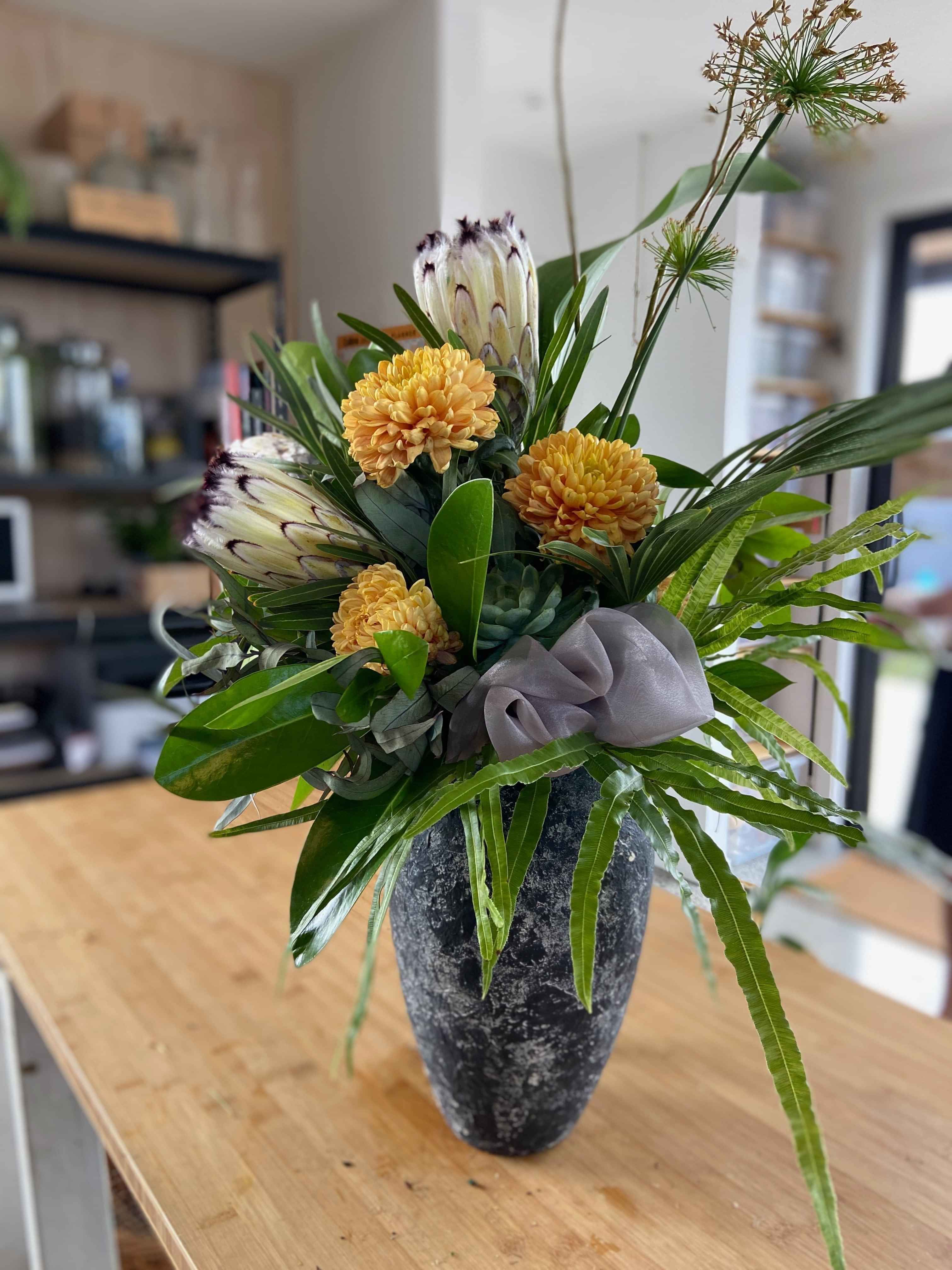 Pure luxury - Bold blooms, rich green foliage in a ceramic vase for workplace florals by Raglan Florist Wild About Eve
