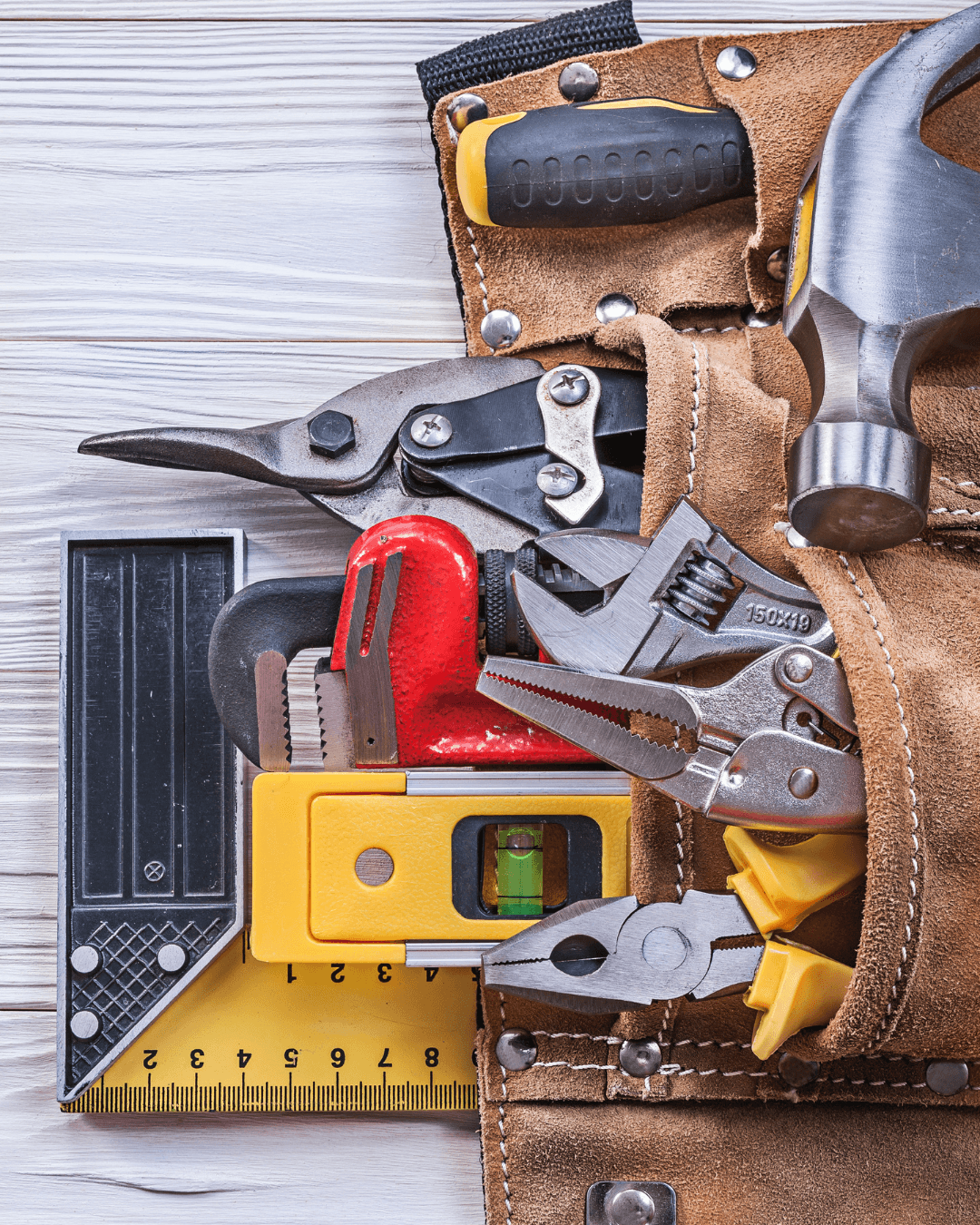 Image of builders belt full of tools on the floor