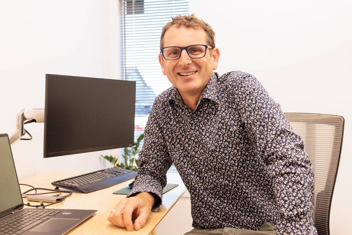 Dr David Waterhouse FRACS ENT surgeon sitting at desk