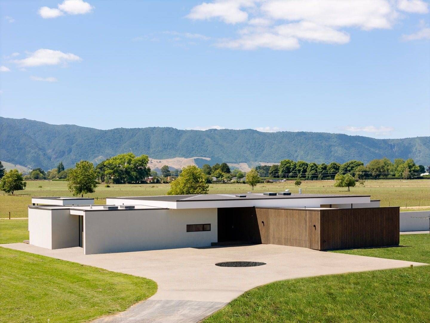 Unique lines and spaces make up the exterior of this large custom build in a beautiful rural farm setting in Waharoa, Waikato