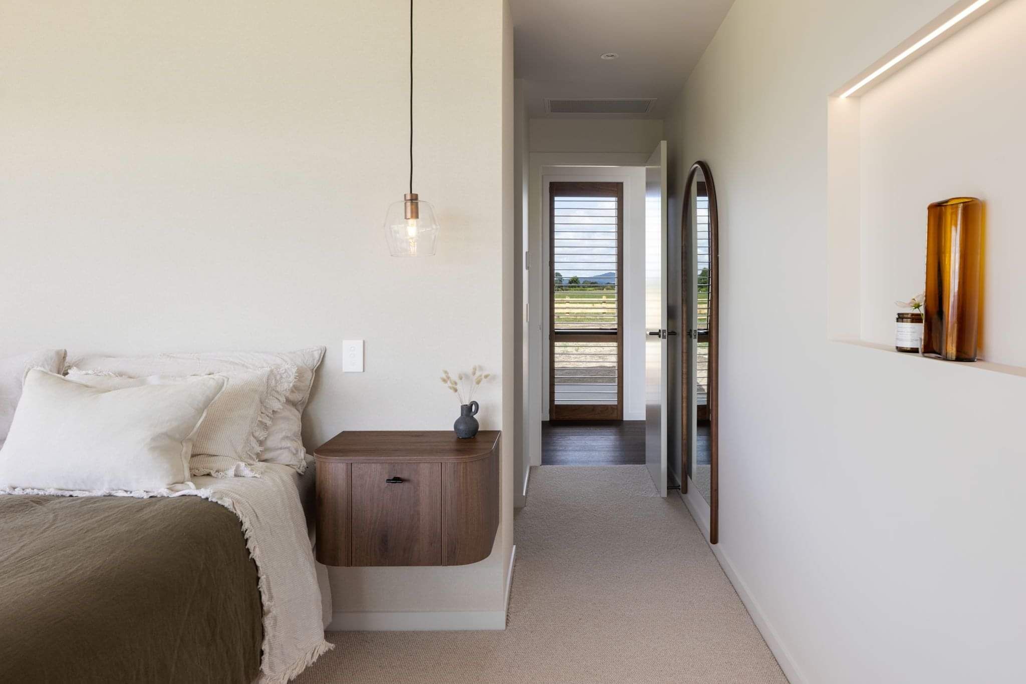 A perfectly positioned window adjacent to the bedroom door makes for a beautiful scene every time you leave the room. 