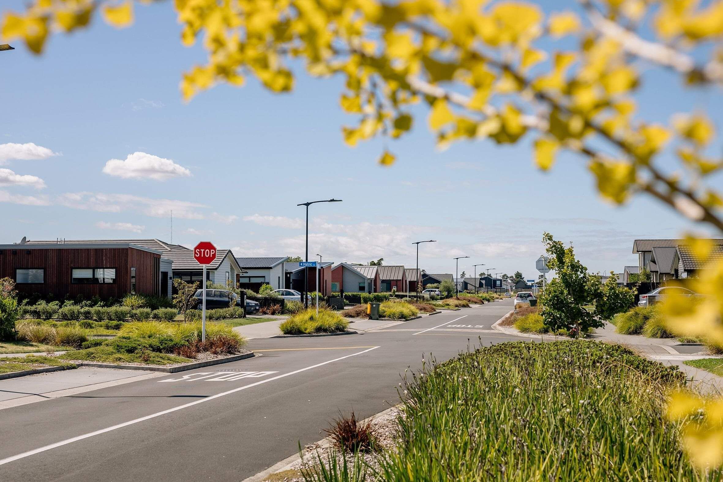 Four way street with stop sign and houses