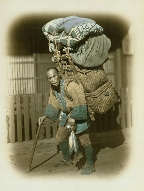 A man carrying a basket full of recycled textile