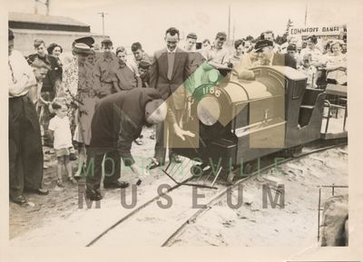 Photo - Wilf Rushton driving the peg in the model railway set up in Thames Street