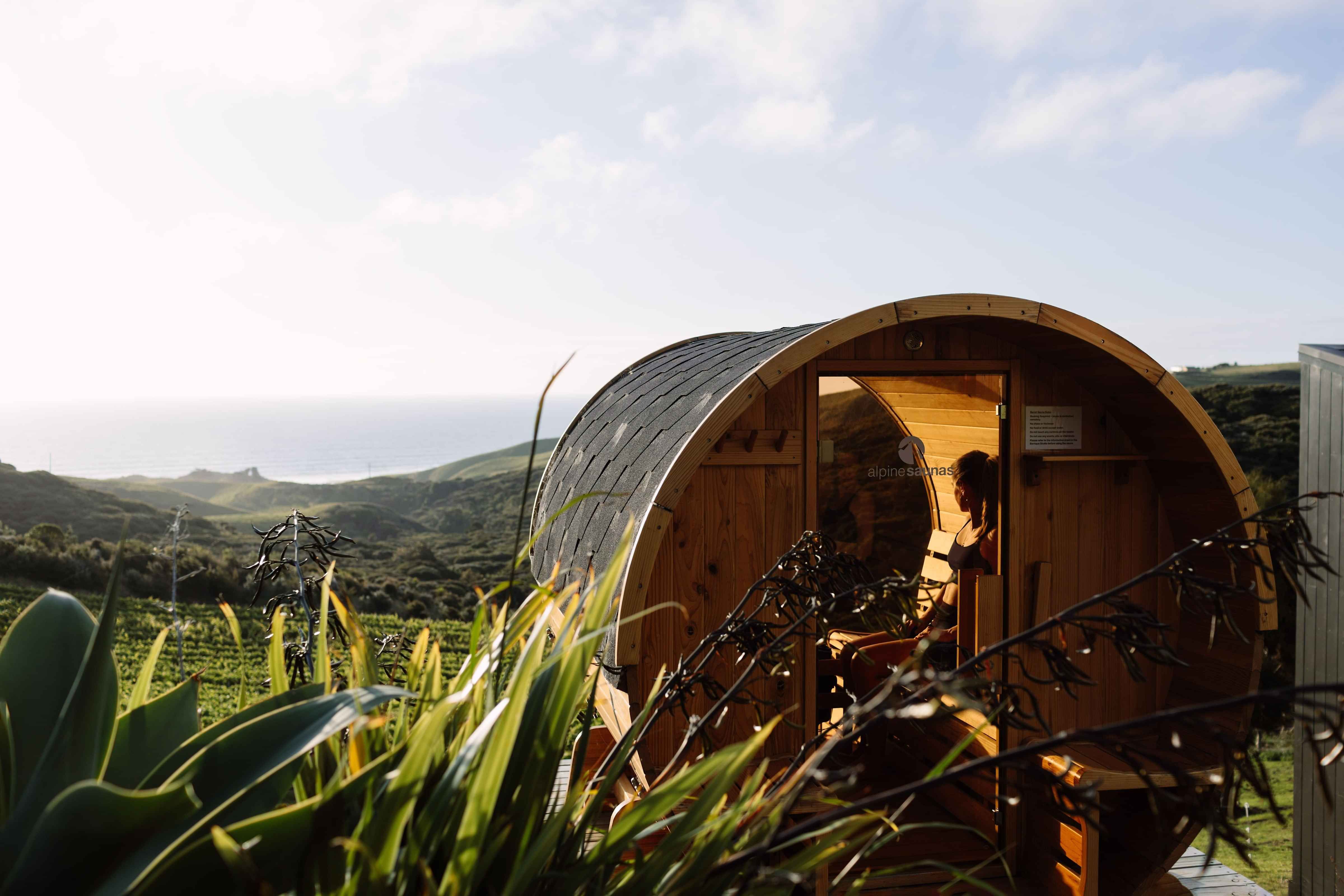 Glass-fronted private barrel sauna overlooking the Tasman Sea at Barrique Studio near Raglan
