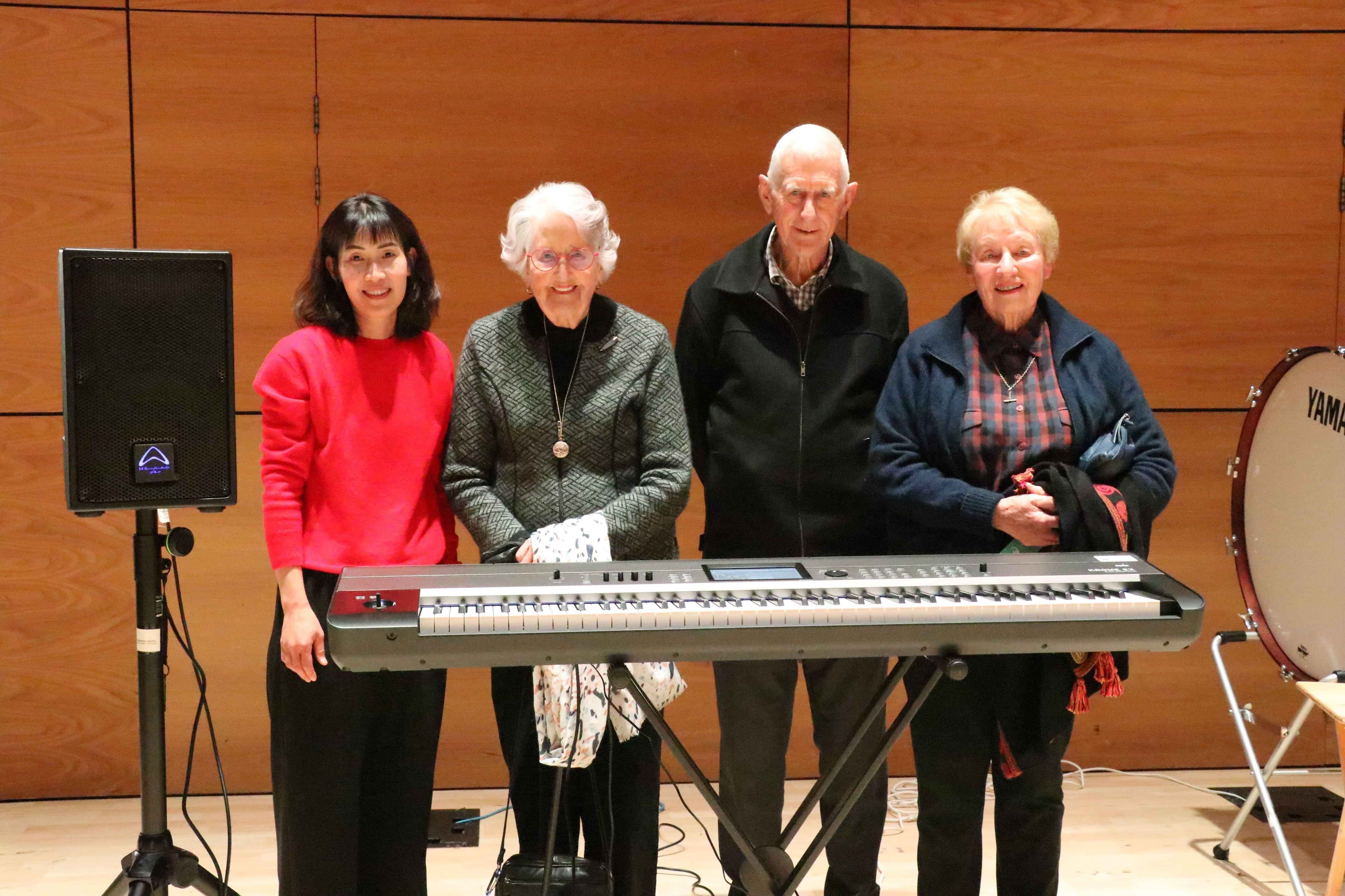 Donors standing behind keyboard