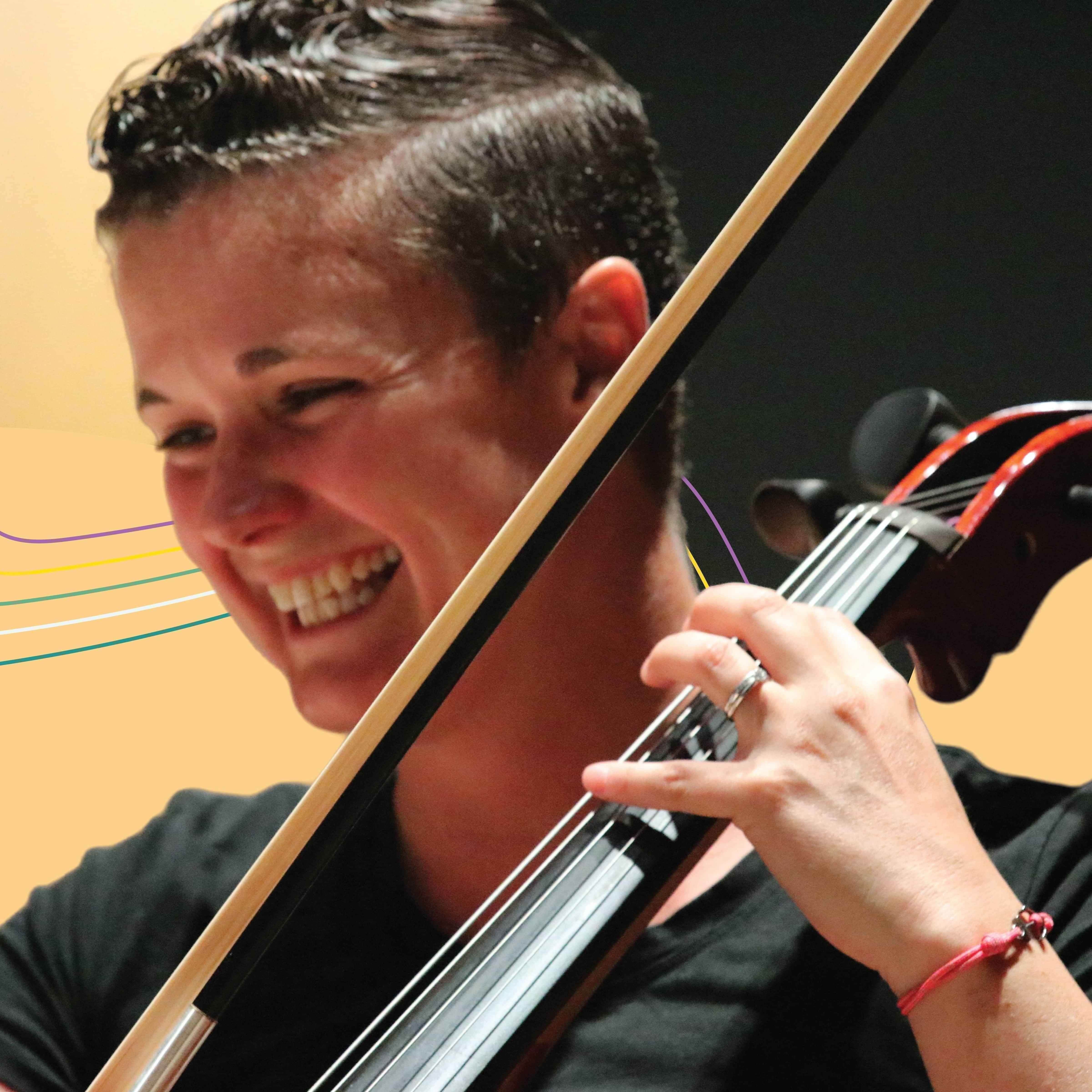 Cellist smiling broadly while playing