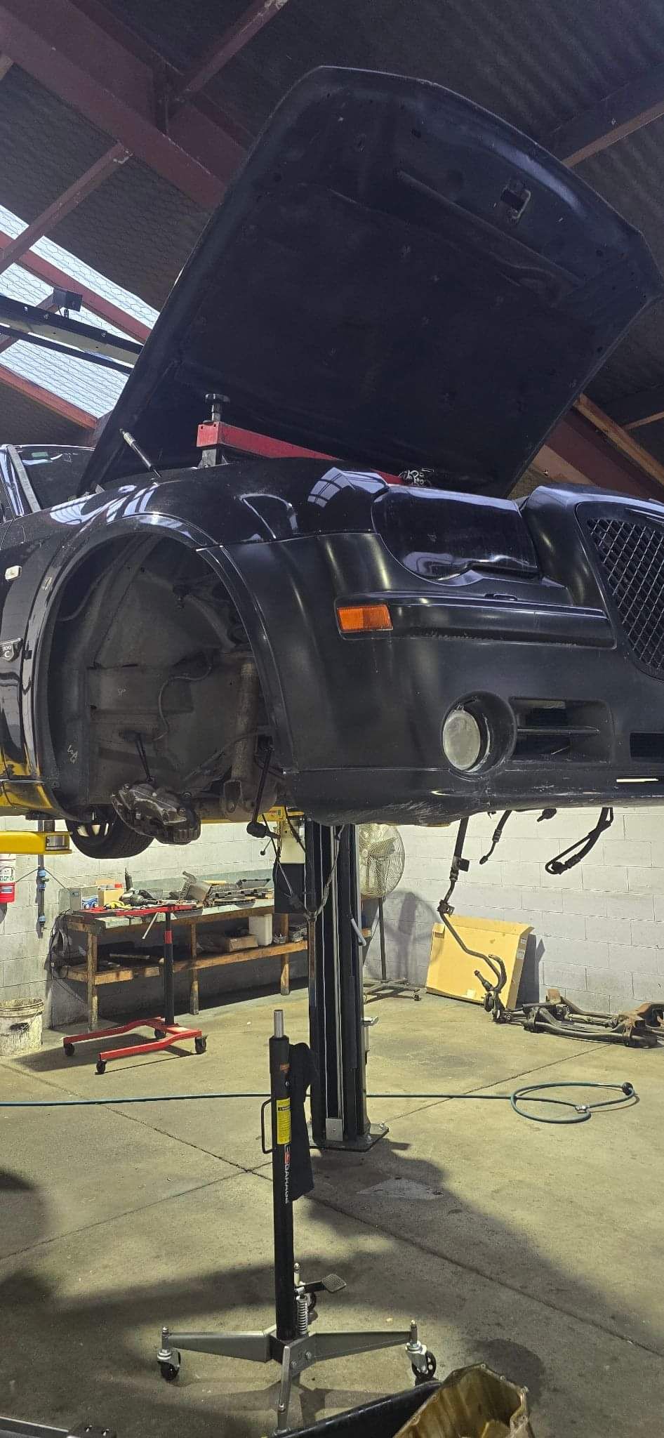 Vehicle raised on a workshop lift at Speedwell Tune and Service Centre