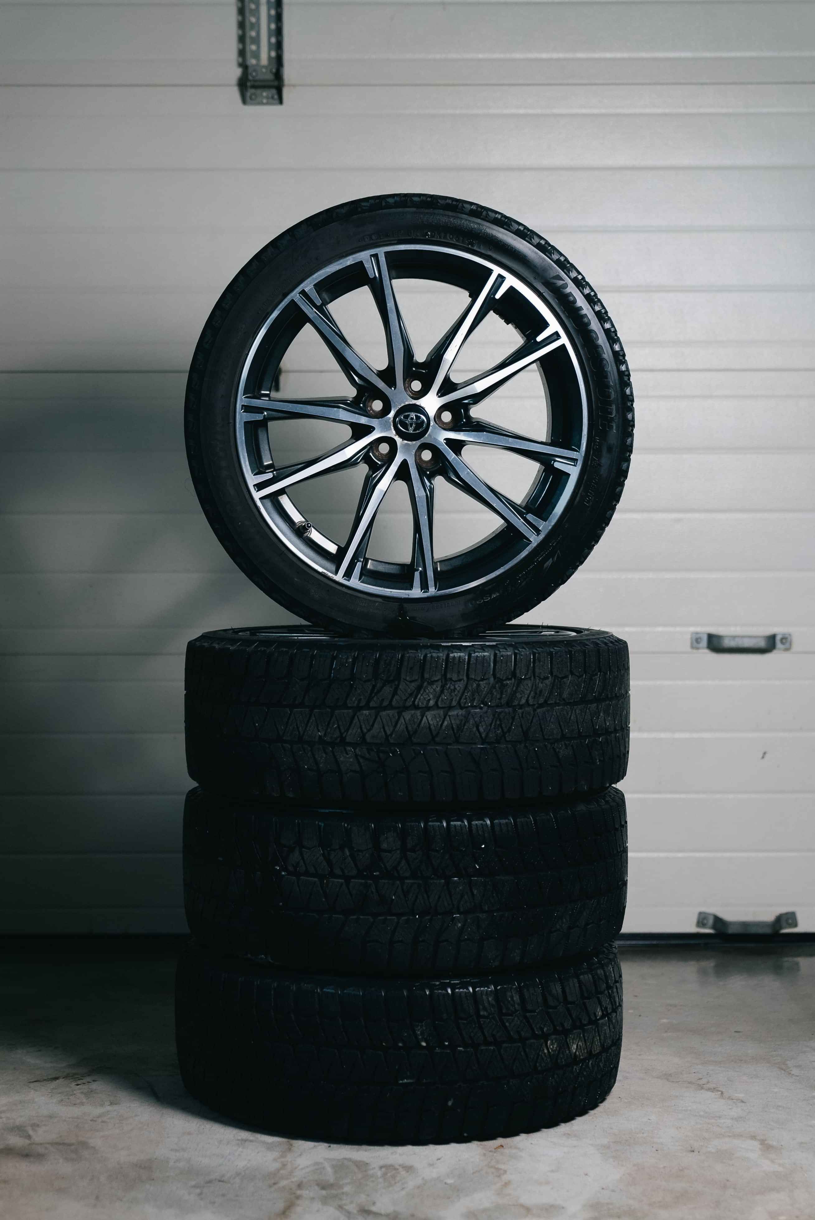 Stacked car tyres with an alloy wheel