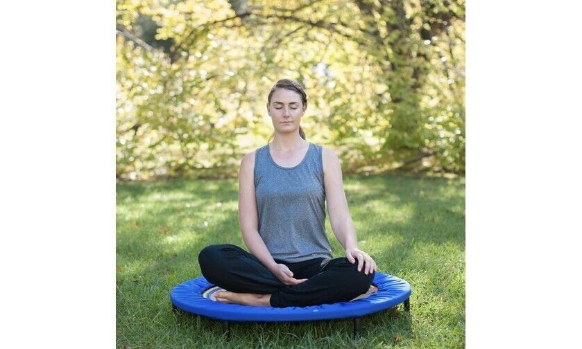 Young yoga woman meditating on the XenPod Lymphaciser & Harmonic Energiser