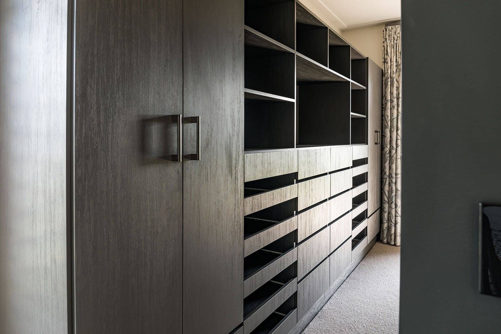 Custom walk-through wardrobe showing drawers and cupboards. 