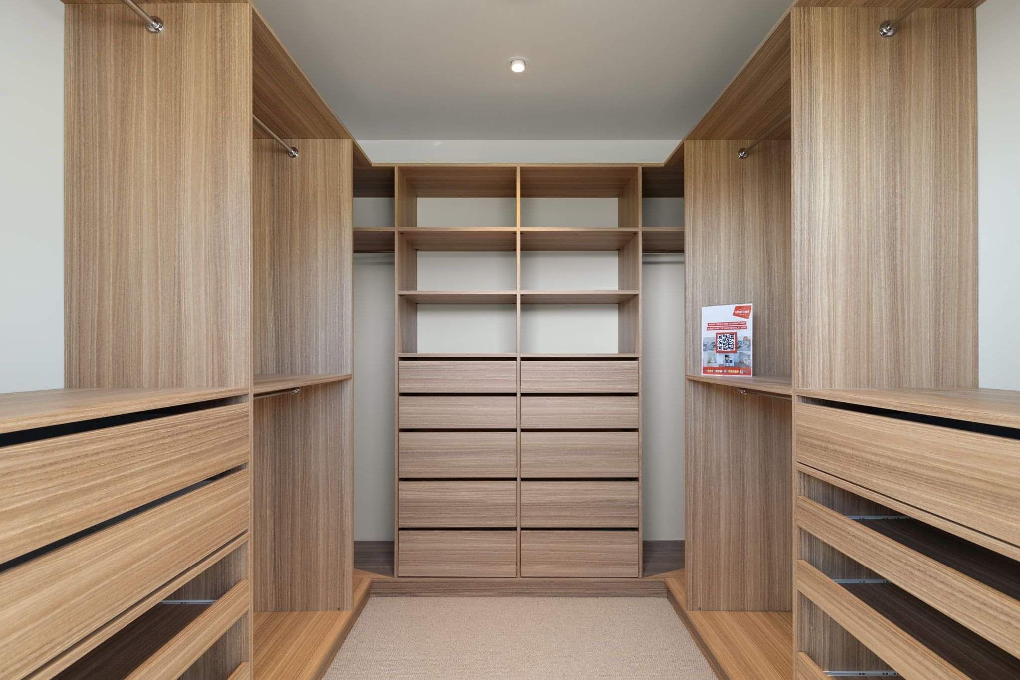 Inside a walk-in closet system showing the style of the Anglesea Wardrobe Closet.