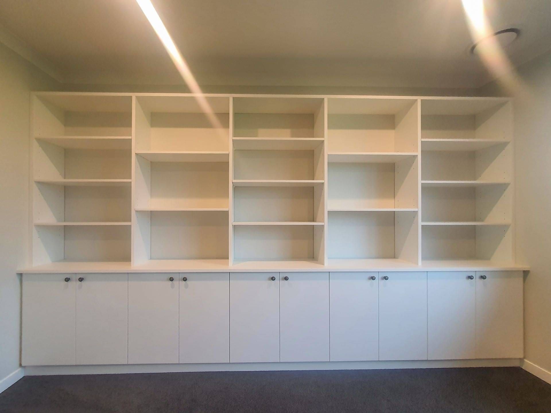 Modern built-in Bookshelves fixed to the wall.