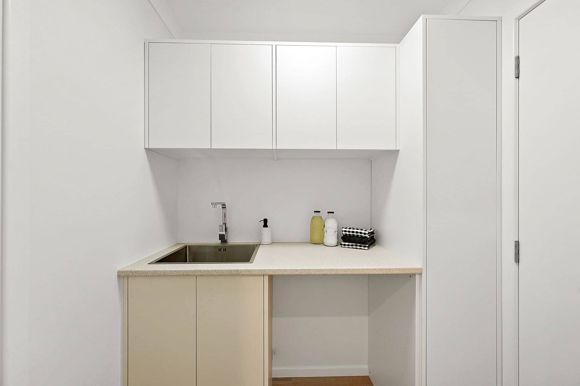 Wall hung cupboards and full height cupboards in white.