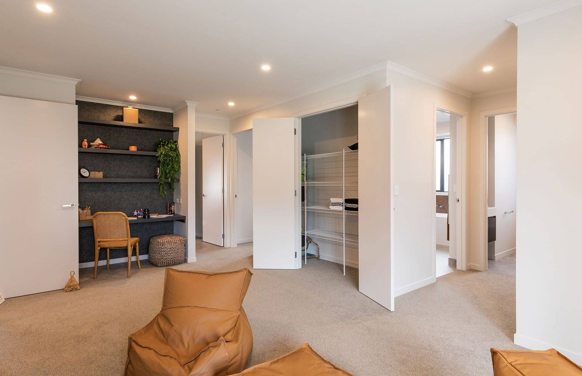Hall cupboard with wire shelving and double swing doors. 