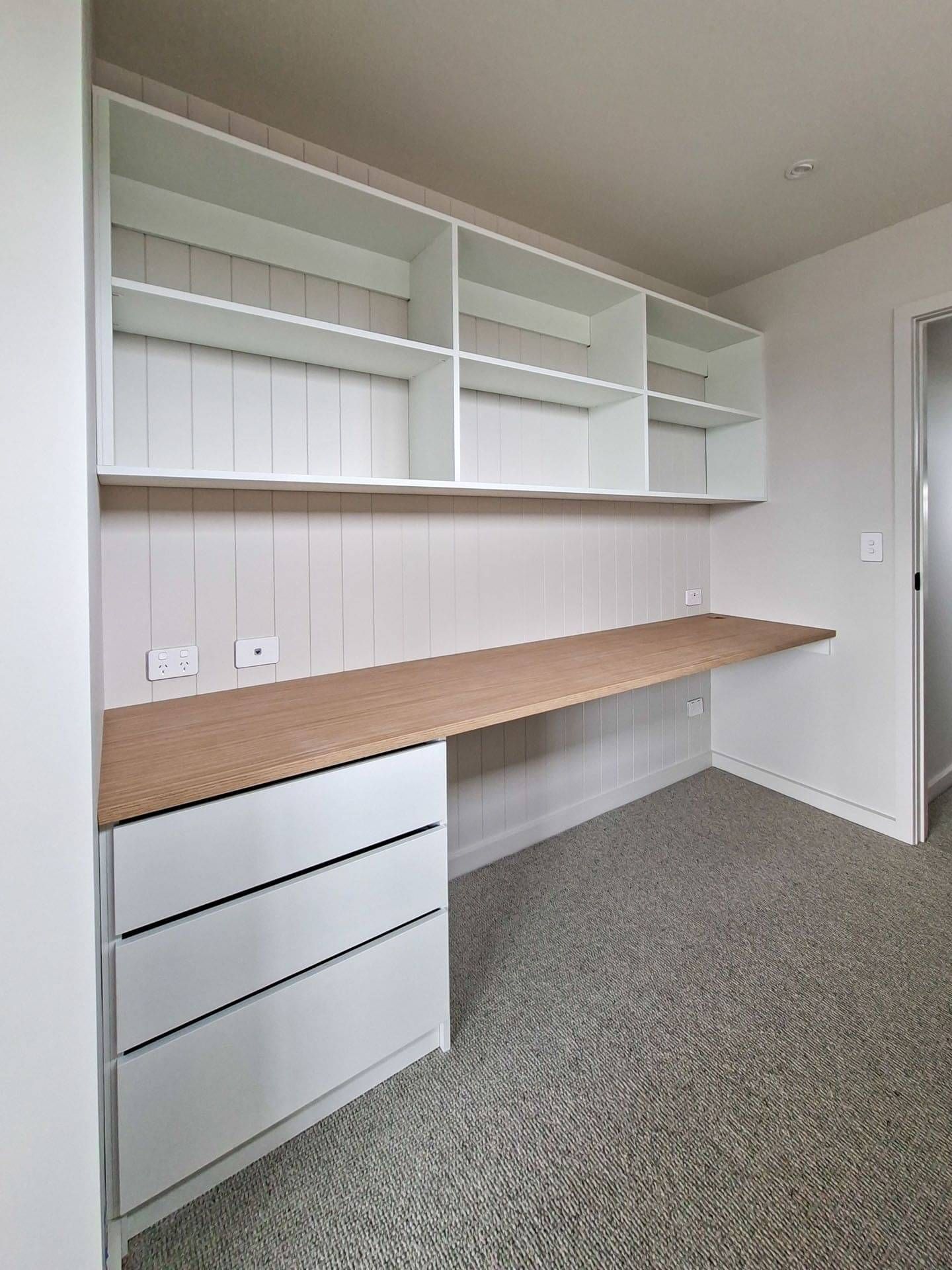 Customised office nook with drawers and shelving.