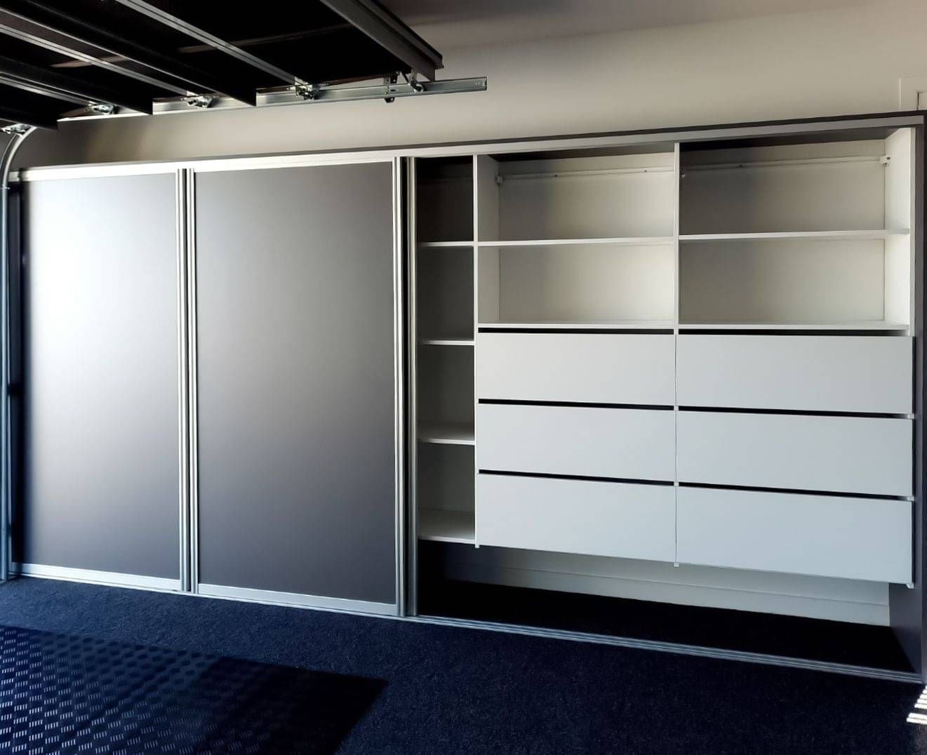 Custom garage storage with custom garage shelving and sliding door.