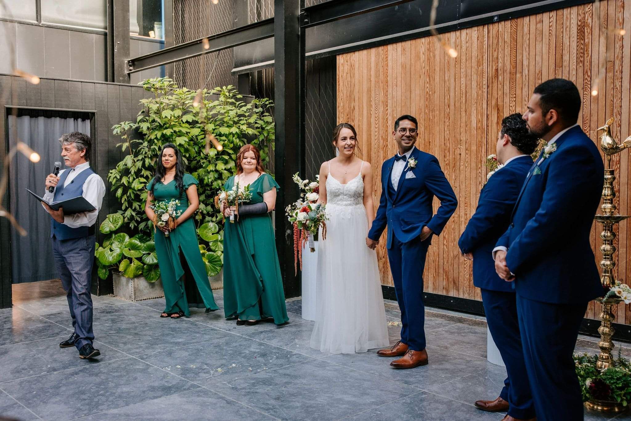 Mark Trubuhovich officiating a wedding ceremony with the couple and wedding party