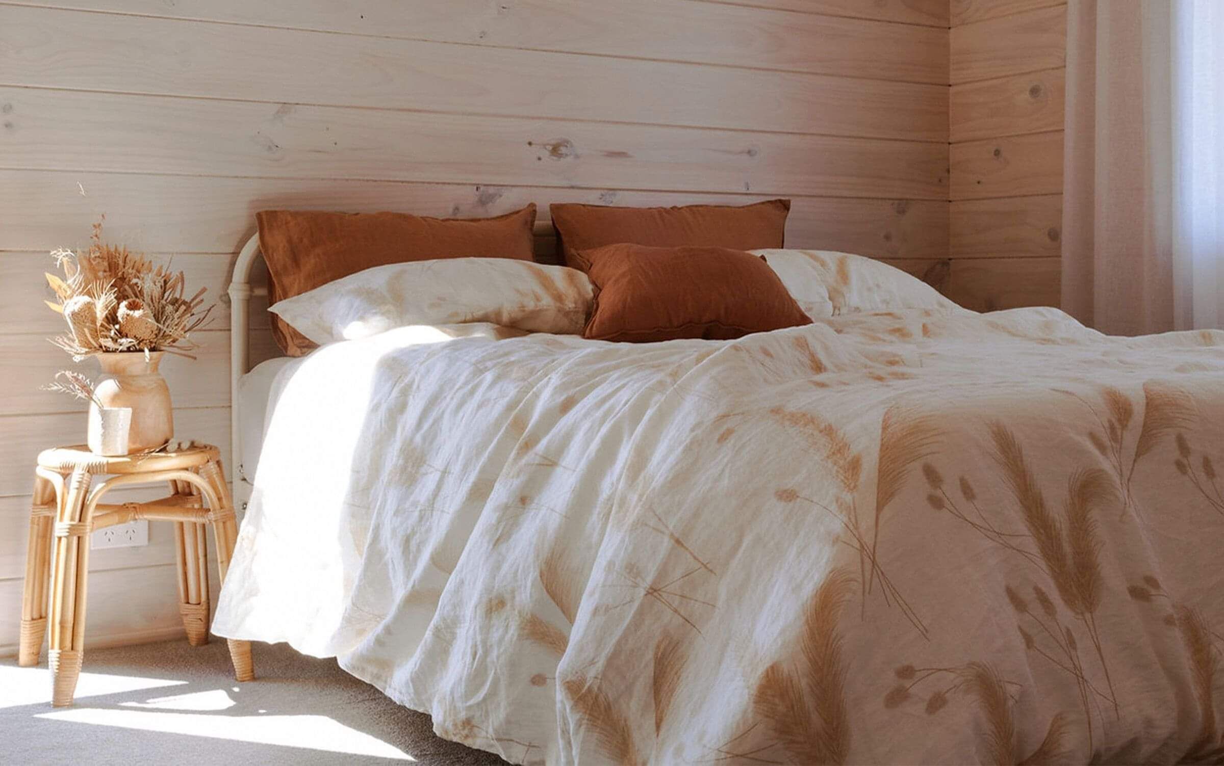 an illustrated duvet cover with toitoi and bunny tail plants on it