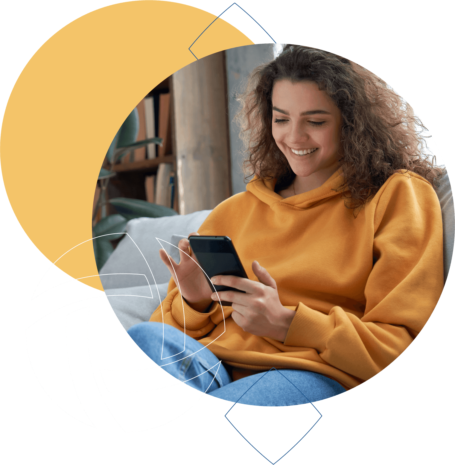 A woman in her mid twenties sitting on a couch looking at her phone