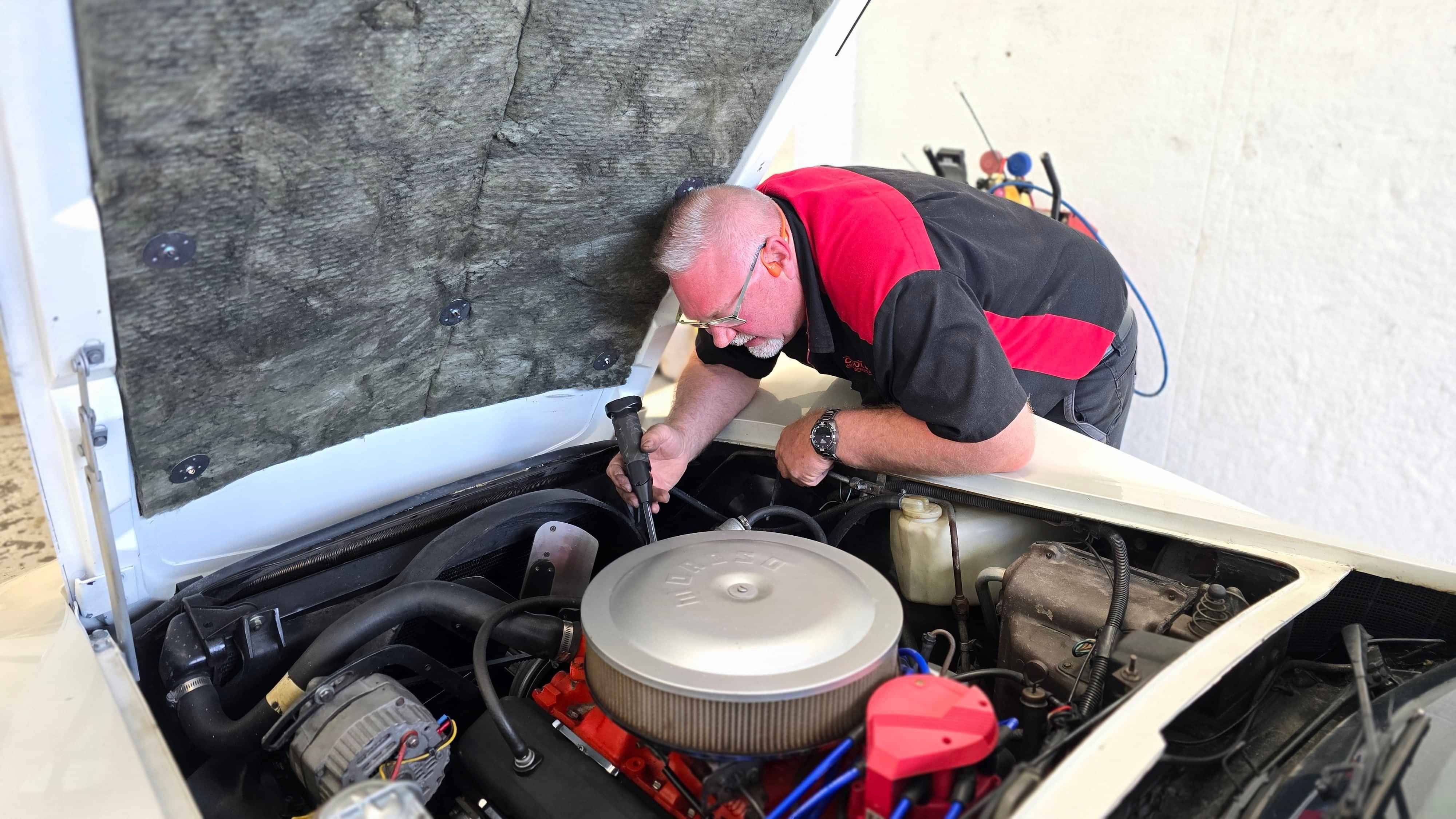 A/C installation expert, Rodney, evaluating a 1977 Chevrolet Corvette to determine what remains of the air-conditioning system