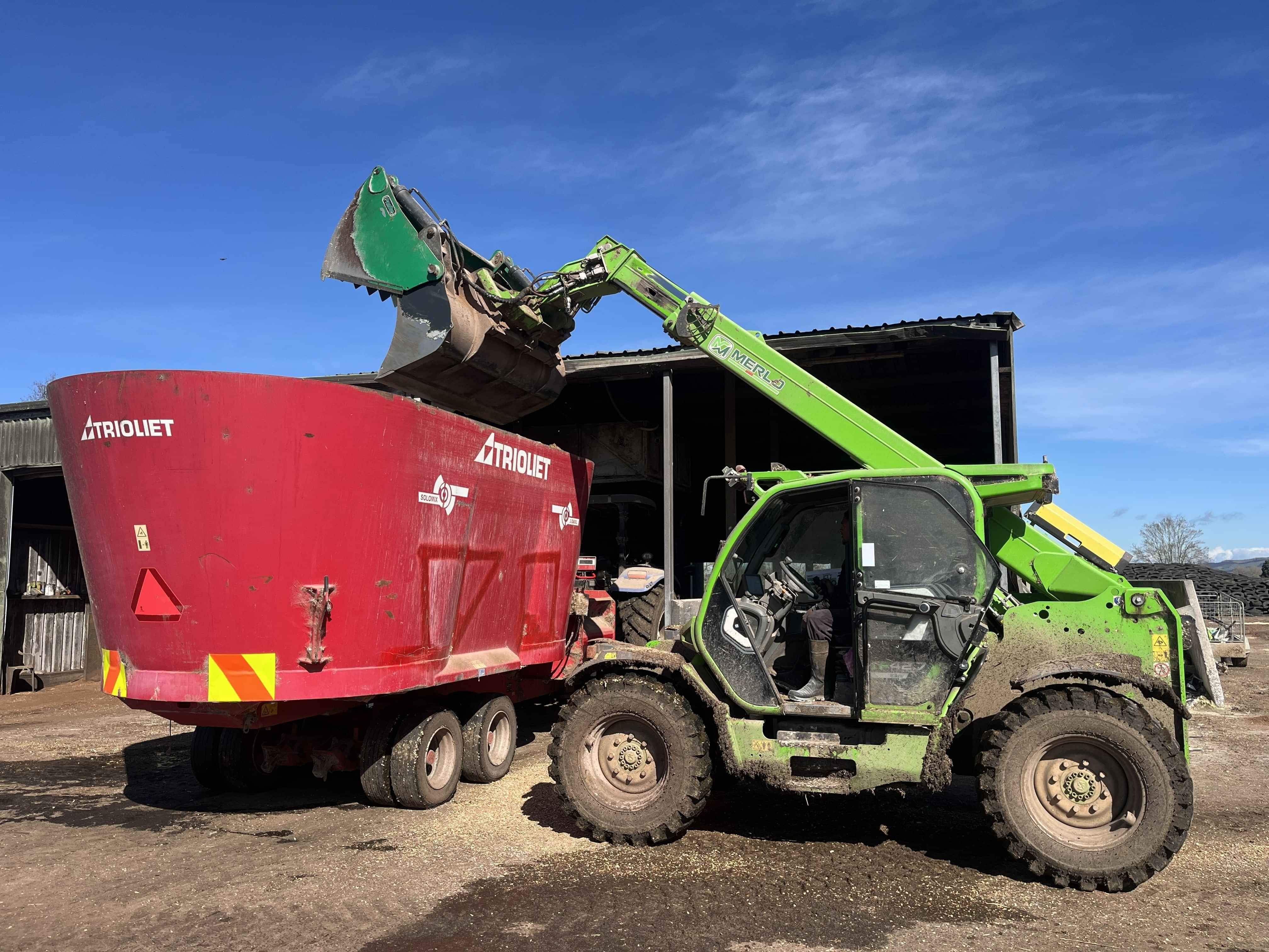 telehandler loading material on farm