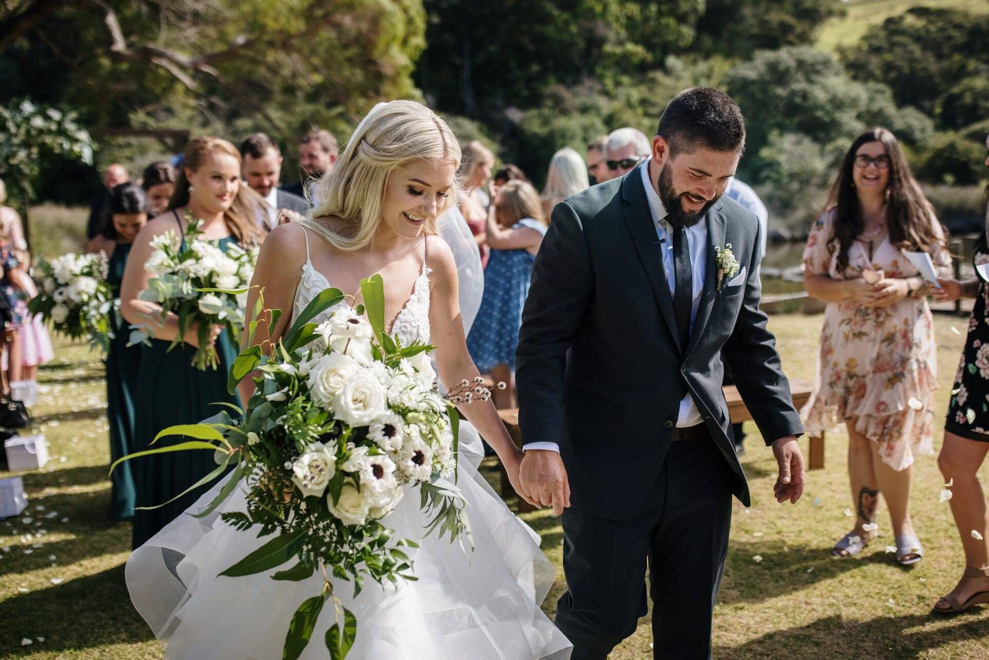 Chanelle and Bradley walking down the aisle