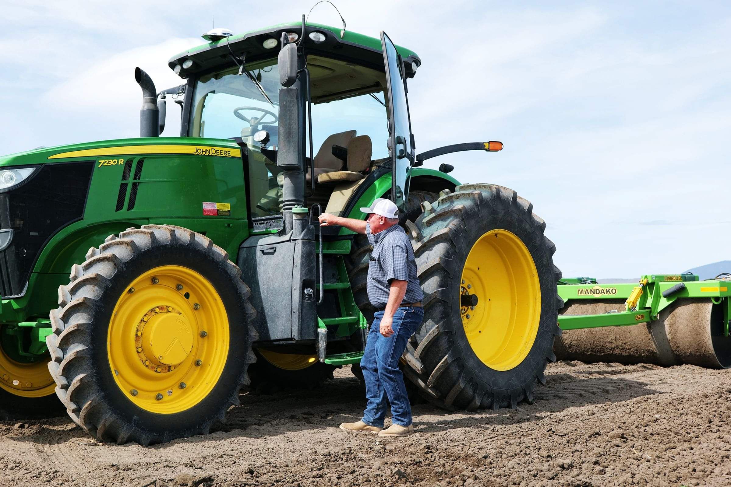 Autonomous tractor with Trimble GPS system performing precision land grading.