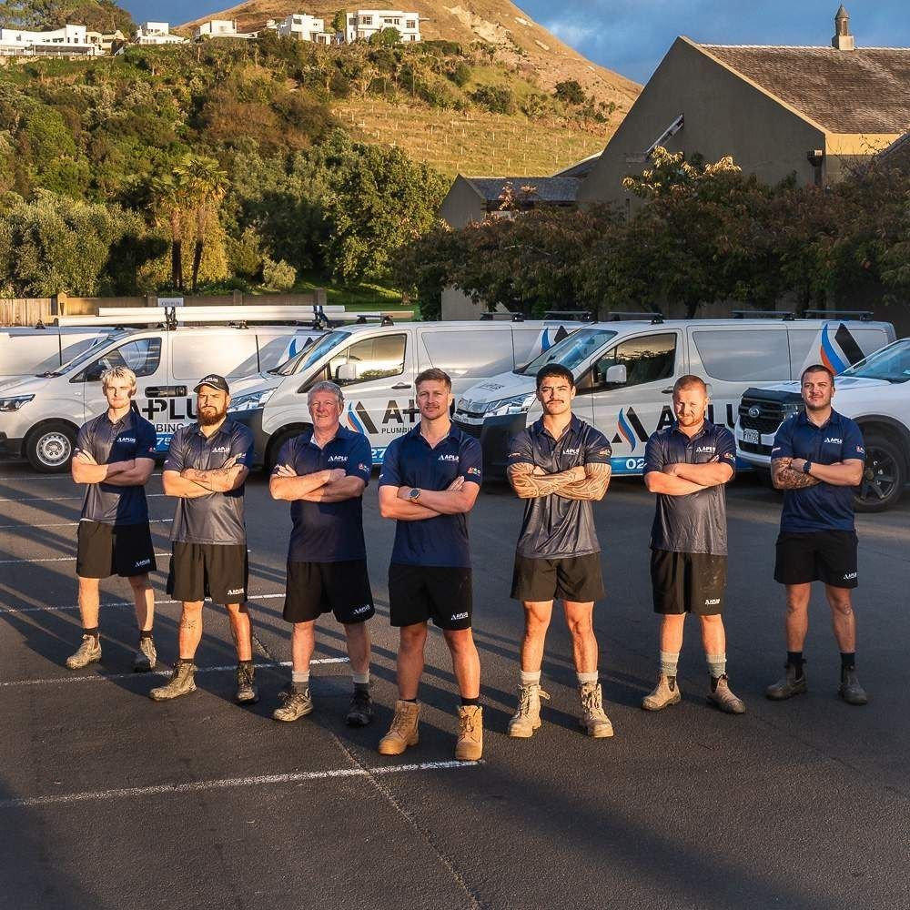 A-Plus Plumbing team lined up in front of branded plumbing vehicles in hastings 