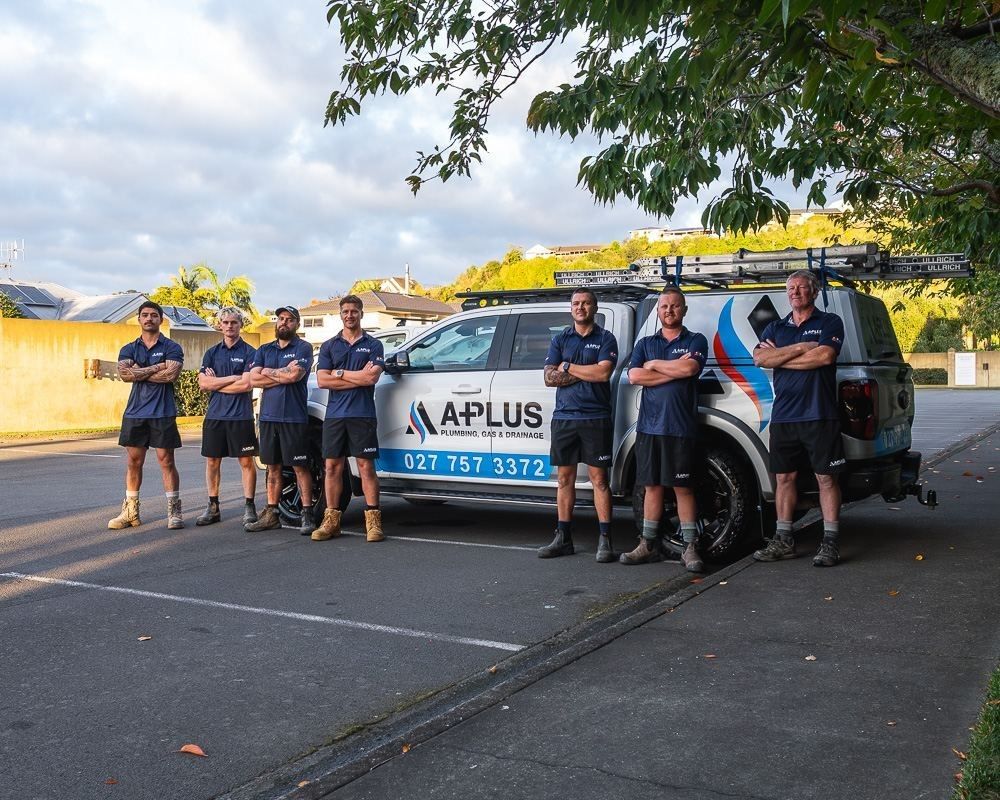 A-Plus Plumbing team lined up in front of branded plumbing vehicles in hastings 