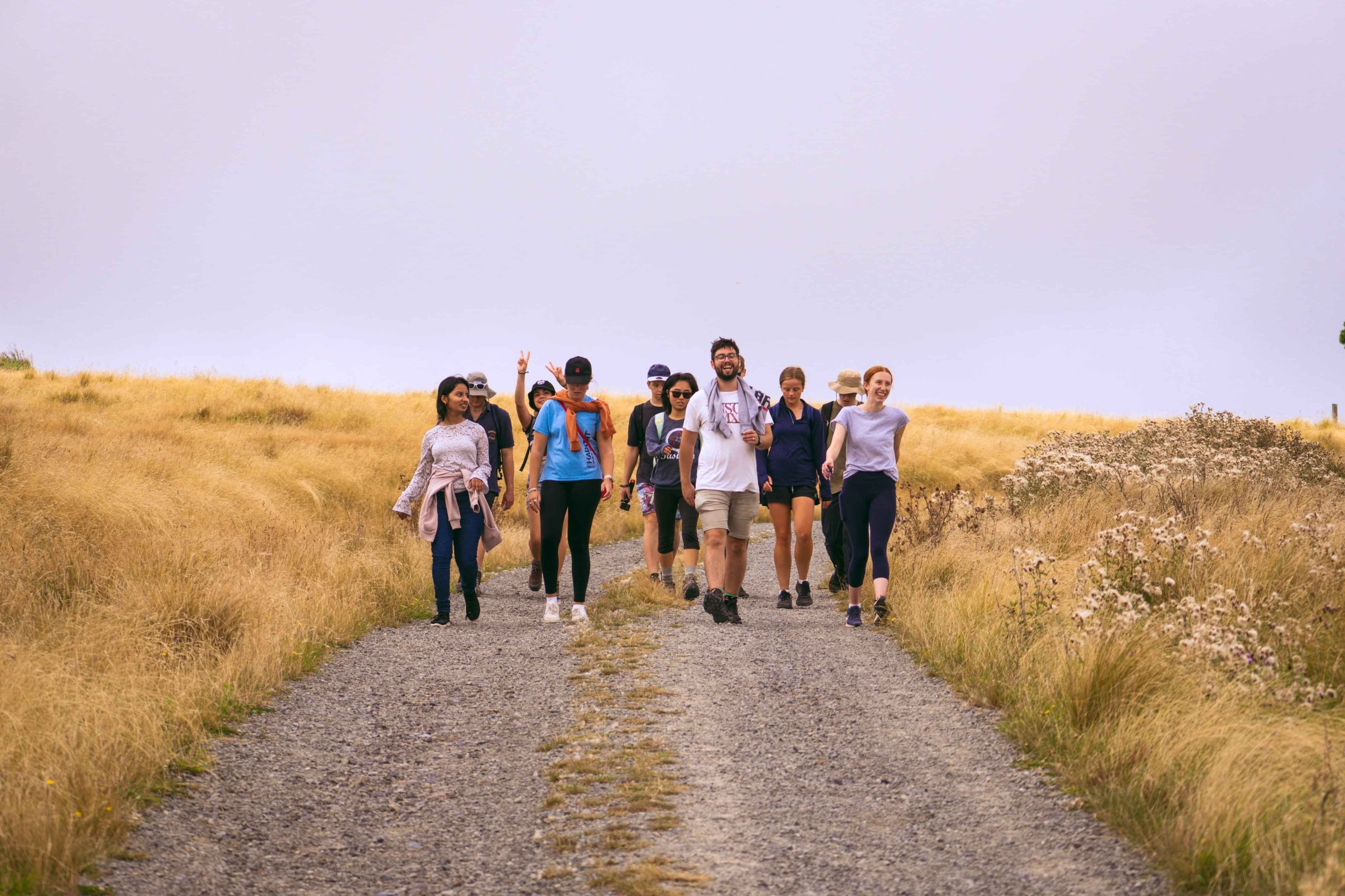 Group of university students walking in Port Hills Christchurch