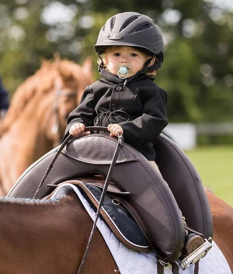Child riding on a pony with an Inky Dinky Saddle and lead rein