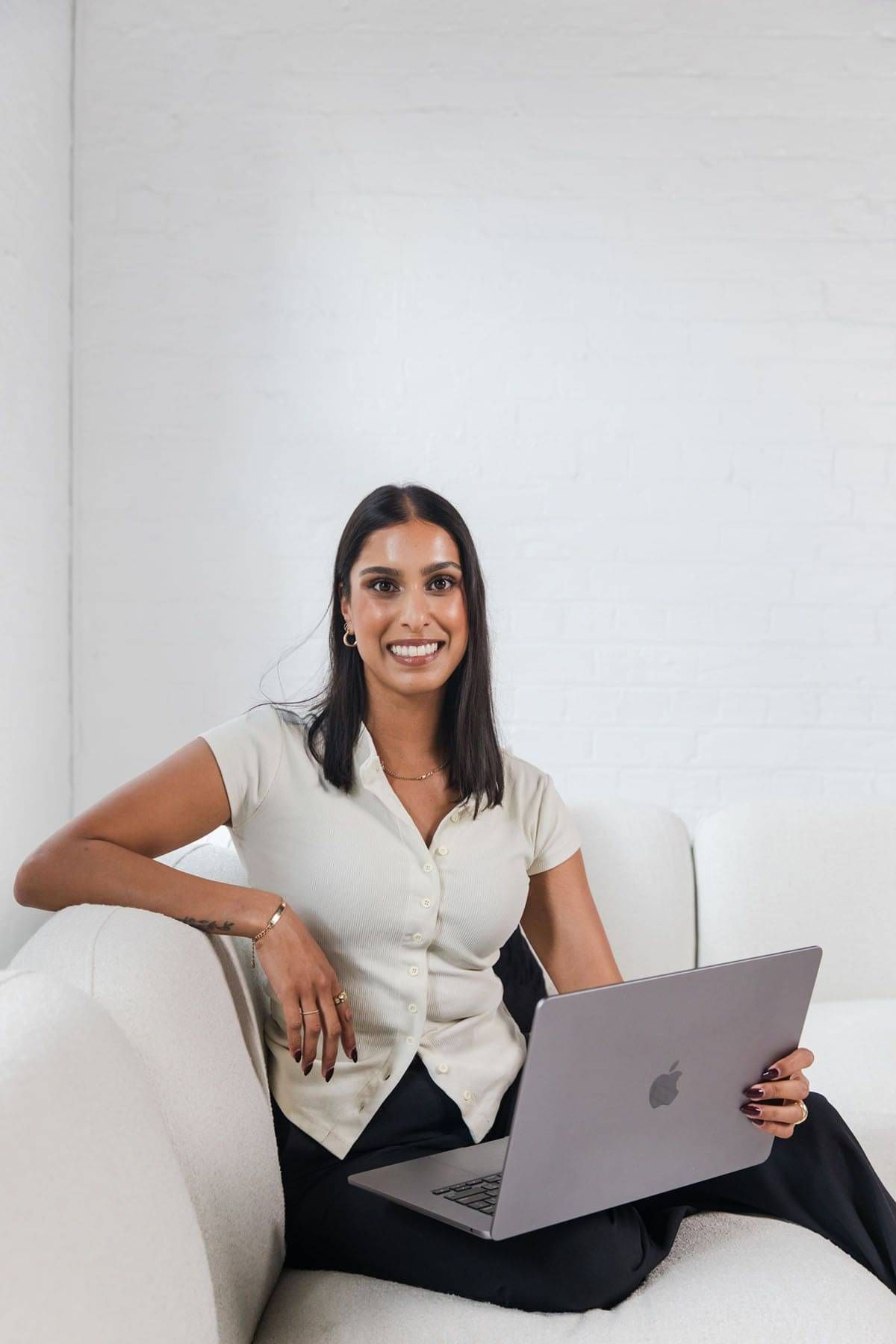 Image of Dynamic Digital founder Tayla sitting on couch