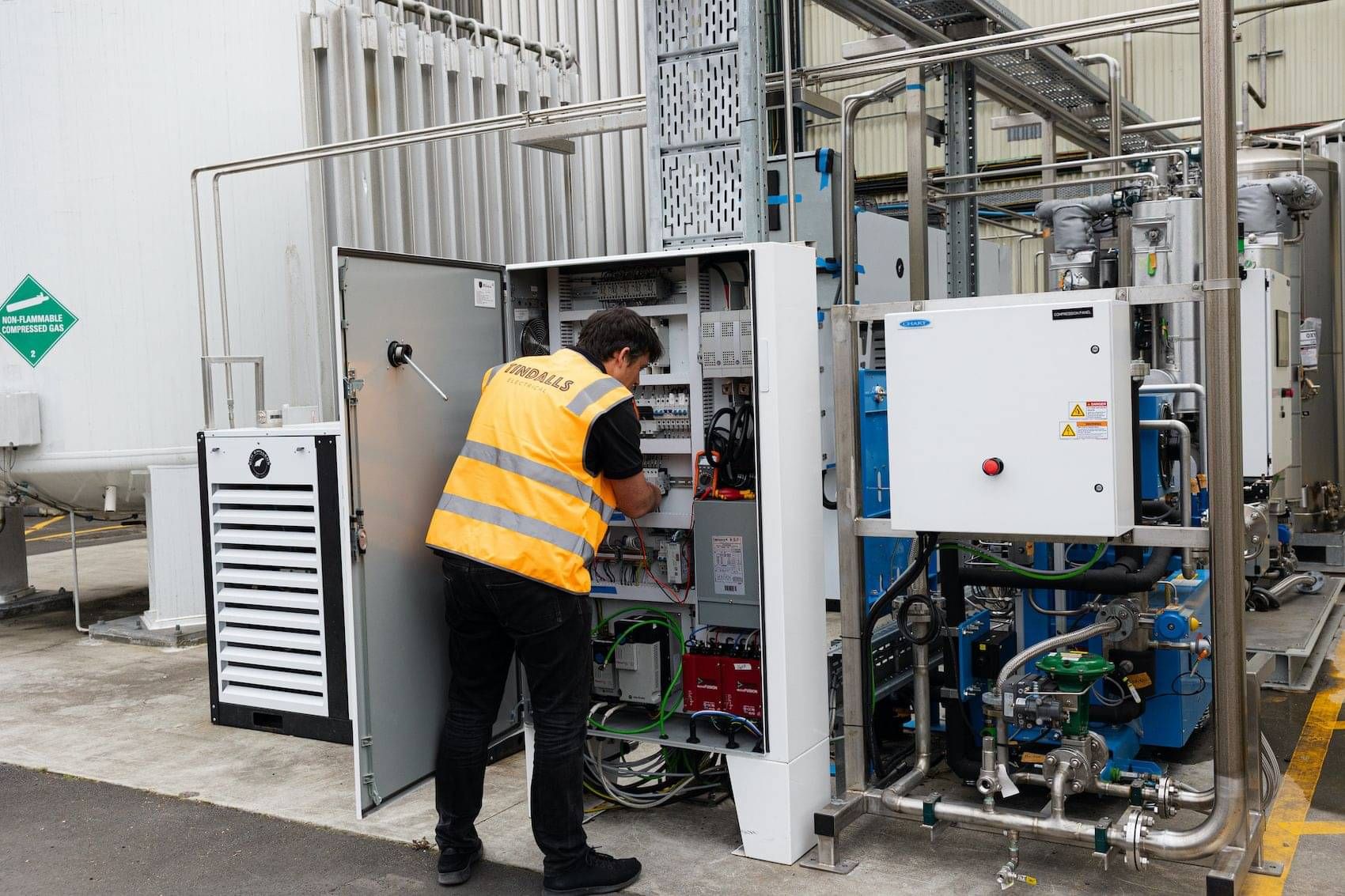 Tindalls electrician carrying out maintenance on commercial equipment