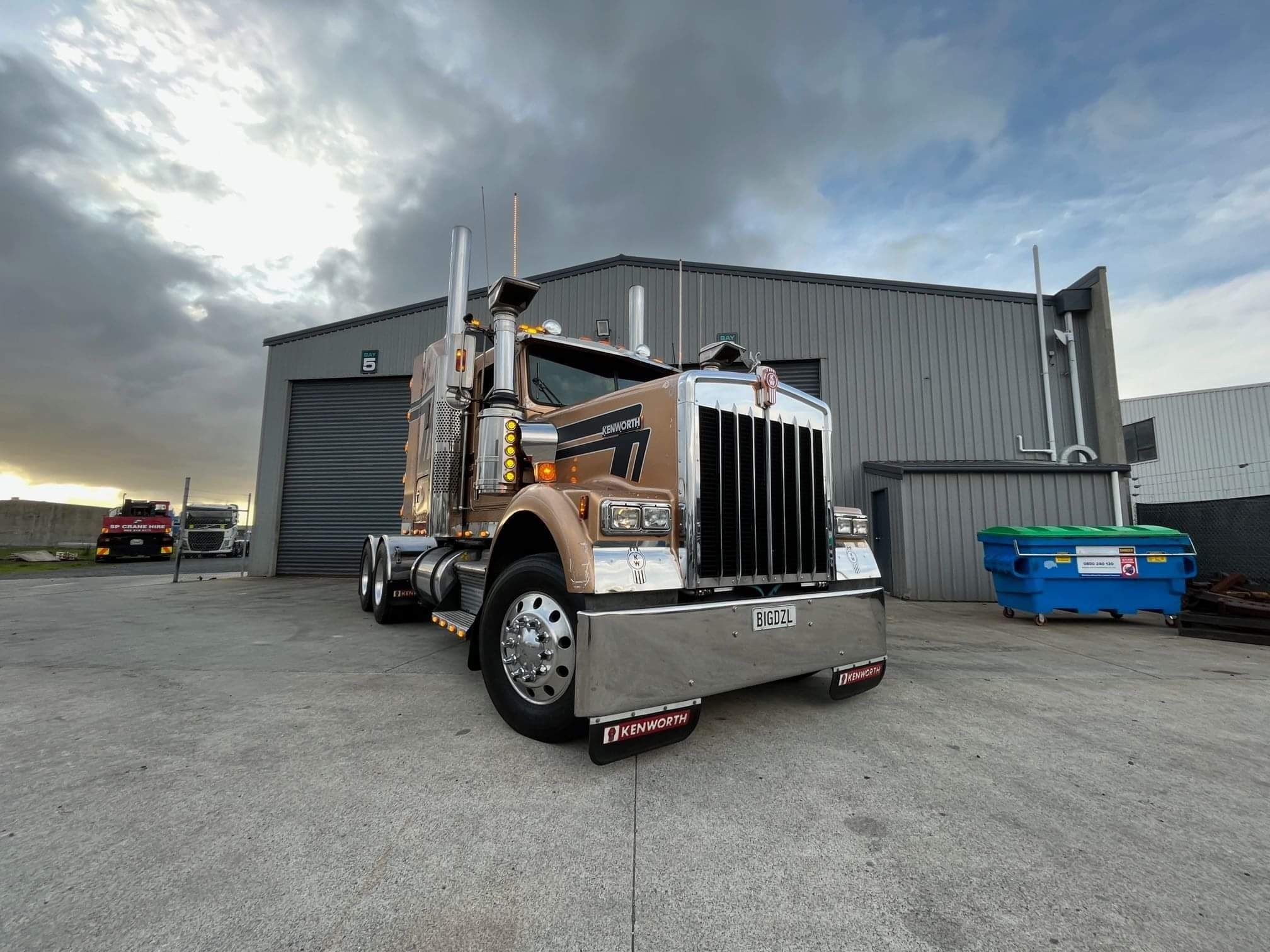Photo of a Kenworth truck parked outside Truckworks Taranaki workshop. License plate reads "BIGDZL" - big diesel